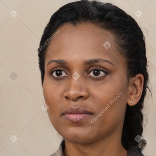 Joyful black young-adult female with long  black hair and brown eyes