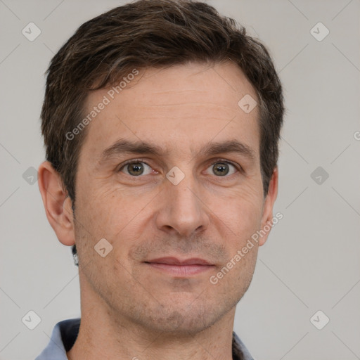 Joyful white adult male with short  brown hair and grey eyes