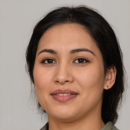 Joyful latino young-adult female with medium  brown hair and brown eyes