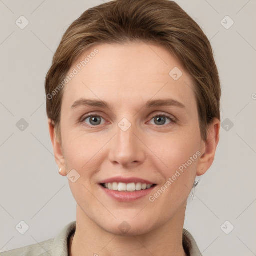 Joyful white young-adult female with short  brown hair and grey eyes