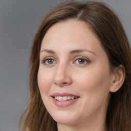 Joyful white adult female with long  brown hair and brown eyes