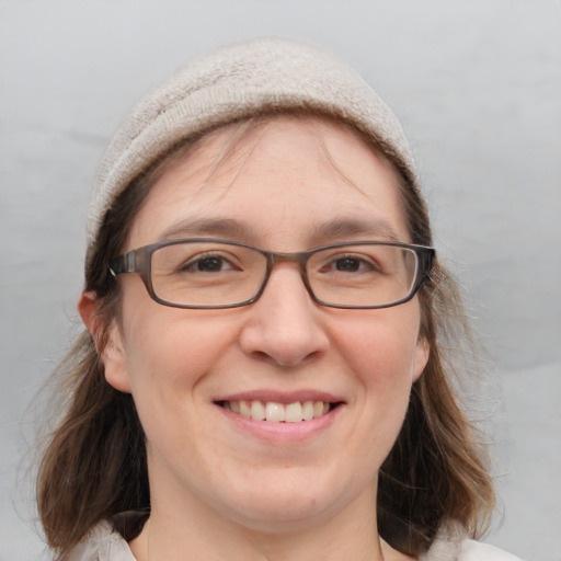 Joyful white adult female with medium  brown hair and blue eyes