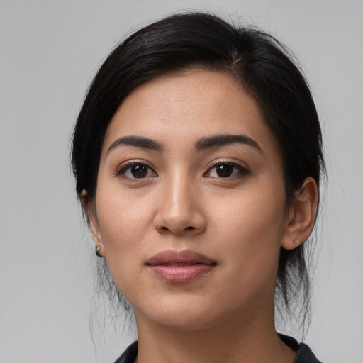 Joyful white young-adult female with medium  black hair and brown eyes