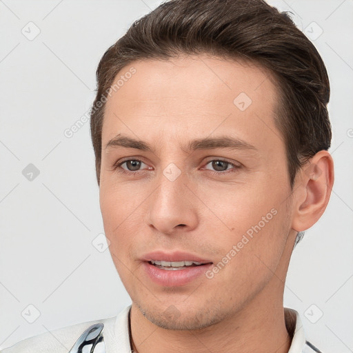 Joyful white young-adult male with short  brown hair and brown eyes