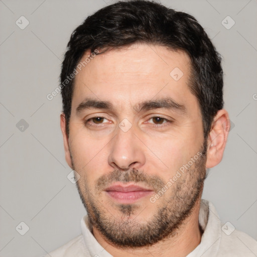 Joyful white young-adult male with short  black hair and brown eyes