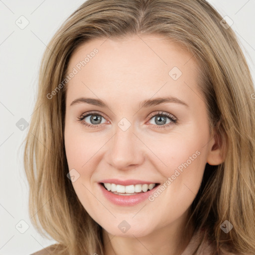 Joyful white young-adult female with long  brown hair and green eyes