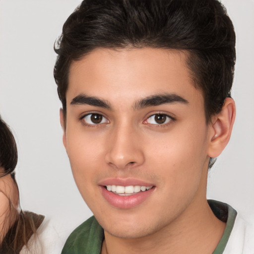 Joyful white young-adult male with medium  brown hair and brown eyes