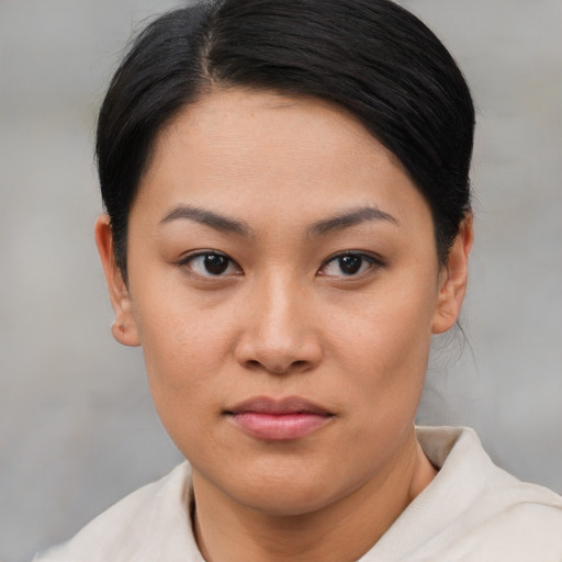 Joyful asian young-adult female with short  brown hair and brown eyes