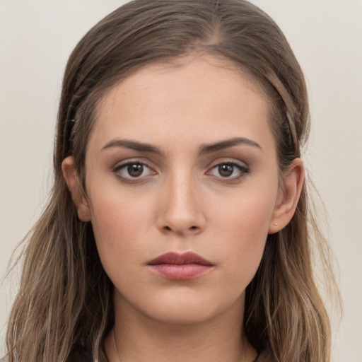 Neutral white young-adult female with long  brown hair and brown eyes