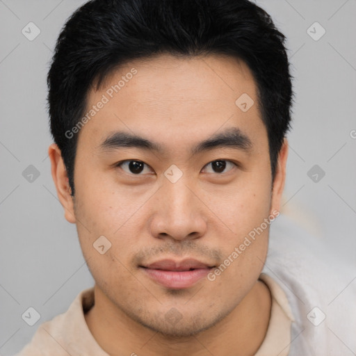 Joyful asian young-adult male with short  black hair and brown eyes