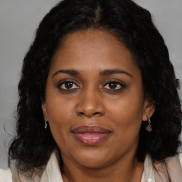 Joyful black adult female with medium  brown hair and brown eyes