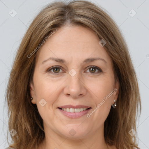 Joyful white adult female with long  brown hair and brown eyes