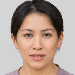 Joyful asian young-adult female with short  brown hair and brown eyes