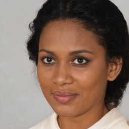 Joyful black young-adult female with medium  brown hair and brown eyes