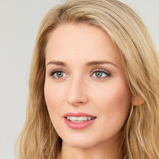 Joyful white young-adult female with long  brown hair and blue eyes