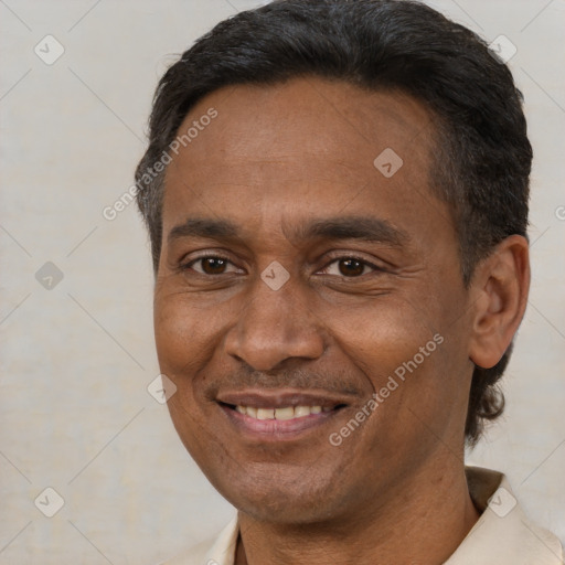 Joyful black adult male with short  black hair and brown eyes