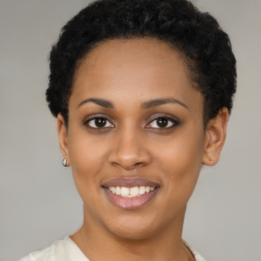 Joyful black young-adult female with short  black hair and brown eyes