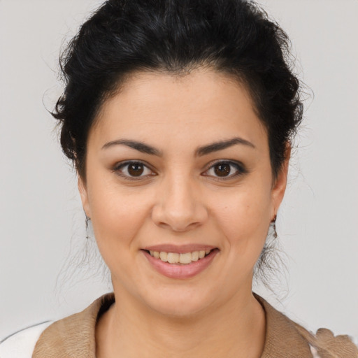 Joyful latino young-adult female with medium  brown hair and brown eyes