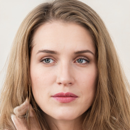 Joyful white young-adult female with long  brown hair and green eyes