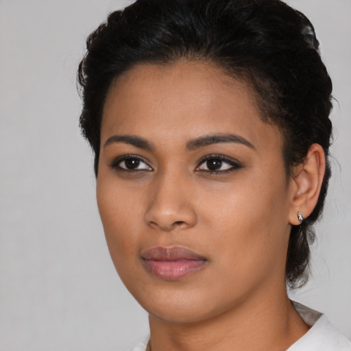 Joyful latino young-adult female with short  brown hair and brown eyes