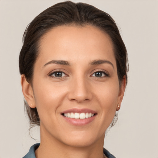 Joyful white young-adult female with medium  brown hair and brown eyes