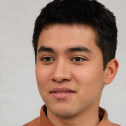 Joyful asian young-adult male with short  black hair and brown eyes