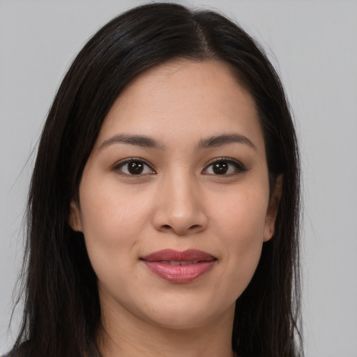 Joyful asian young-adult female with long  brown hair and brown eyes