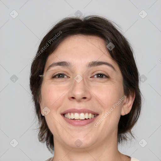 Joyful white adult female with medium  brown hair and brown eyes