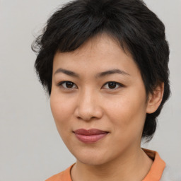 Joyful asian young-adult female with short  brown hair and brown eyes