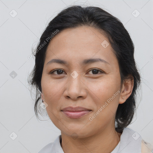 Joyful asian adult female with medium  brown hair and brown eyes