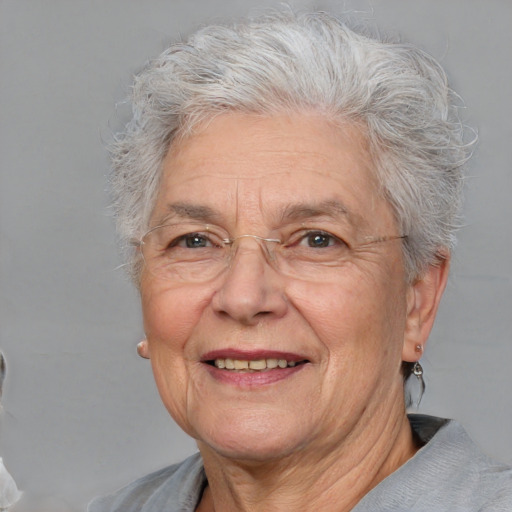 Joyful white middle-aged female with short  gray hair and brown eyes