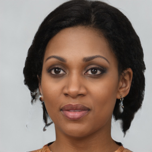 Joyful black young-adult female with medium  black hair and brown eyes