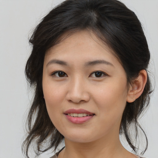 Joyful asian young-adult female with medium  brown hair and brown eyes