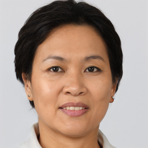 Joyful asian adult female with short  brown hair and brown eyes