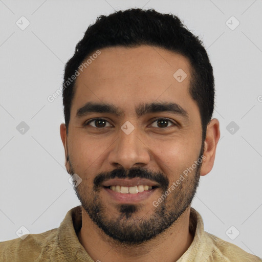 Joyful latino young-adult male with short  black hair and brown eyes