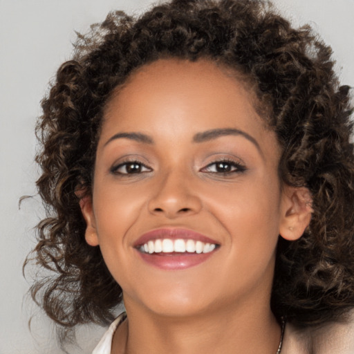 Joyful latino young-adult female with long  brown hair and brown eyes