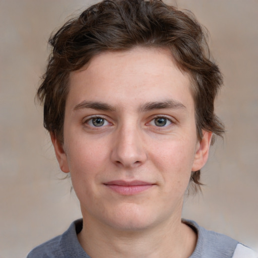 Joyful white young-adult male with medium  brown hair and grey eyes