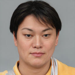 Joyful asian young-adult female with short  brown hair and brown eyes