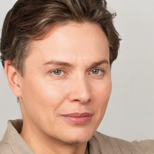 Joyful white adult male with short  brown hair and grey eyes