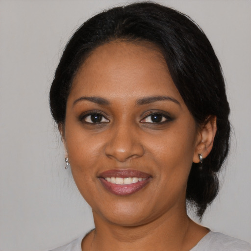 Joyful black young-adult female with medium  black hair and brown eyes