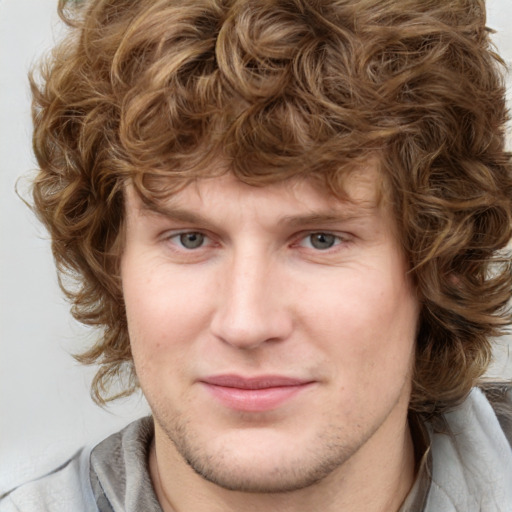 Joyful white young-adult male with medium  brown hair and blue eyes