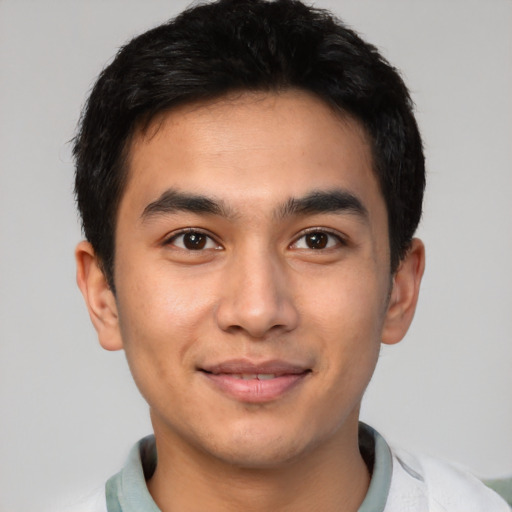 Joyful latino young-adult male with short  black hair and brown eyes