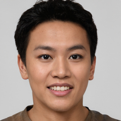 Joyful white young-adult male with short  black hair and brown eyes