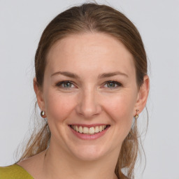 Joyful white young-adult female with medium  brown hair and grey eyes