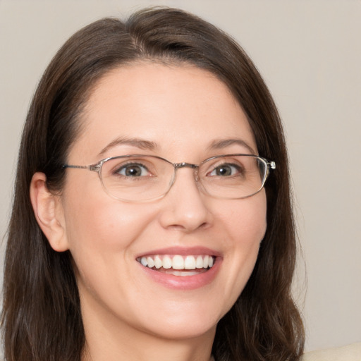 Joyful white adult female with medium  brown hair and brown eyes