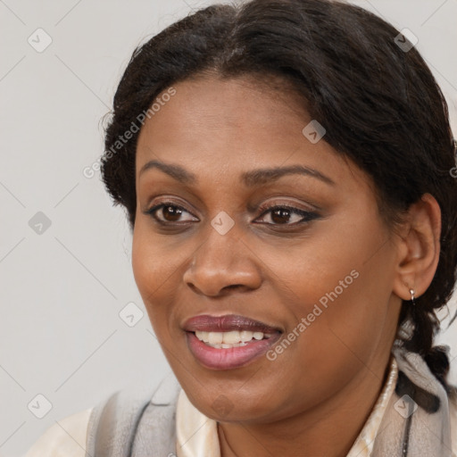 Joyful black young-adult female with long  brown hair and brown eyes