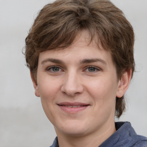 Joyful white young-adult female with short  brown hair and grey eyes