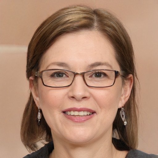 Joyful white adult female with medium  brown hair and blue eyes