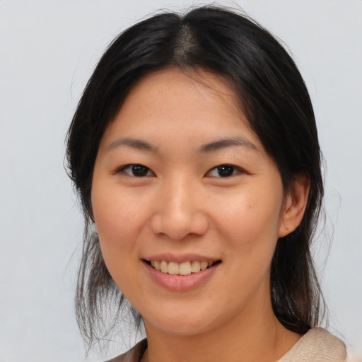 Joyful asian young-adult female with medium  brown hair and brown eyes