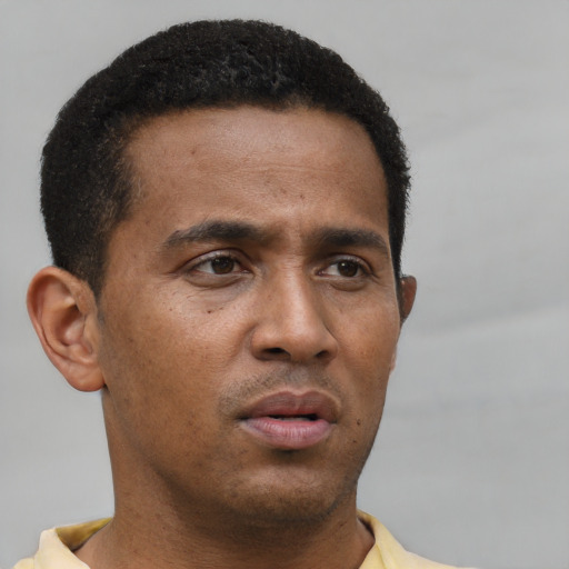 Neutral latino young-adult male with short  brown hair and brown eyes